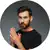 portrait of bearded man in black t shirt looking a AXTQACS
